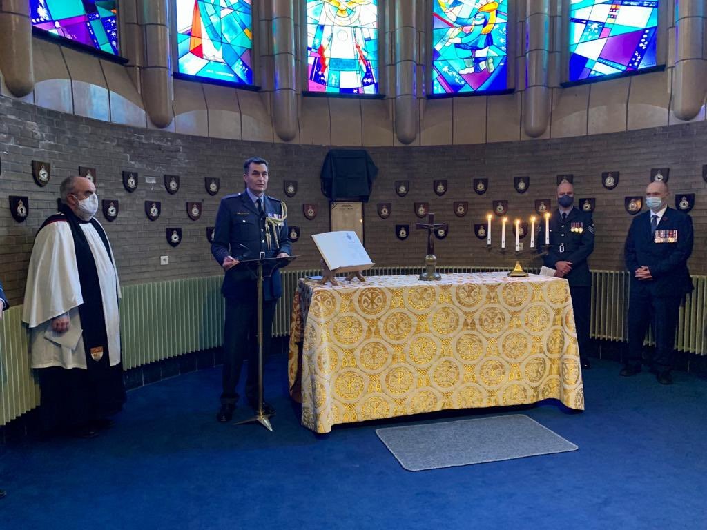 Personnel stand by table during ceremony.